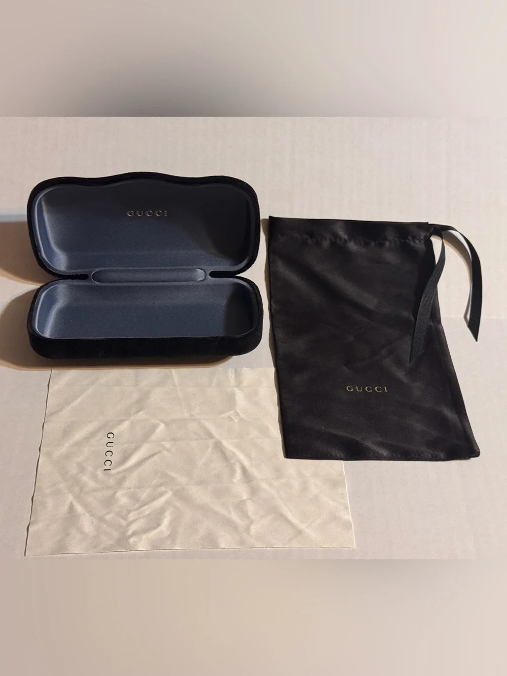 A Gucci Eyewear Case in Black and Dark Gray with Gold Logo
